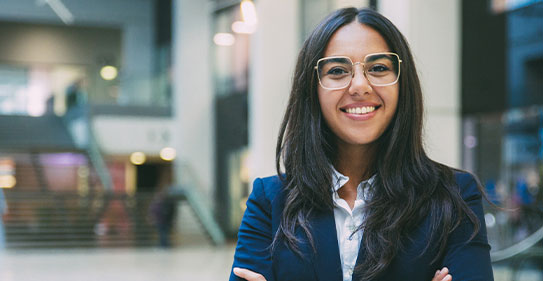 A confident, smiling businesswoman in a suit.